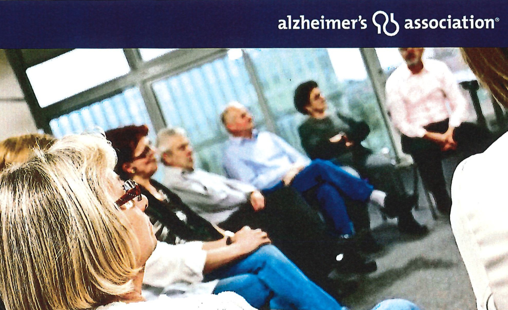 image of a group of people at a support group meeting with text alzheimer's association