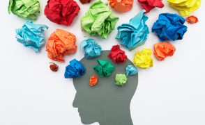 image of head silhouette with colorful paper thought bubbles