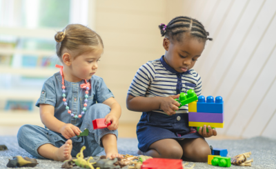 Image of two children playing with objects