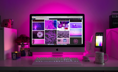 Computer monitor on a desk with a pink aura around it