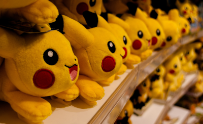 A shelf of stuffed Pikachu toys
